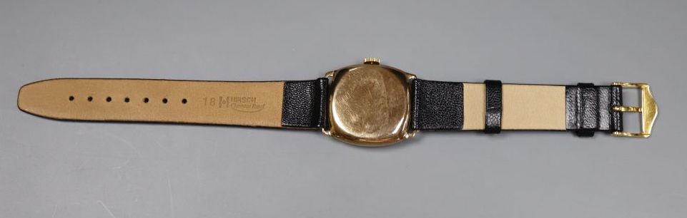 A gentlemans early 1930s 9ct gold manual wind wrist watch, with checkered dial, on later strap.